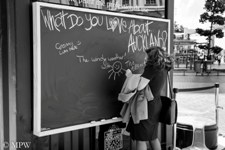 Black and white street scene, blackboard art or graffiti in Queen St, Auckland